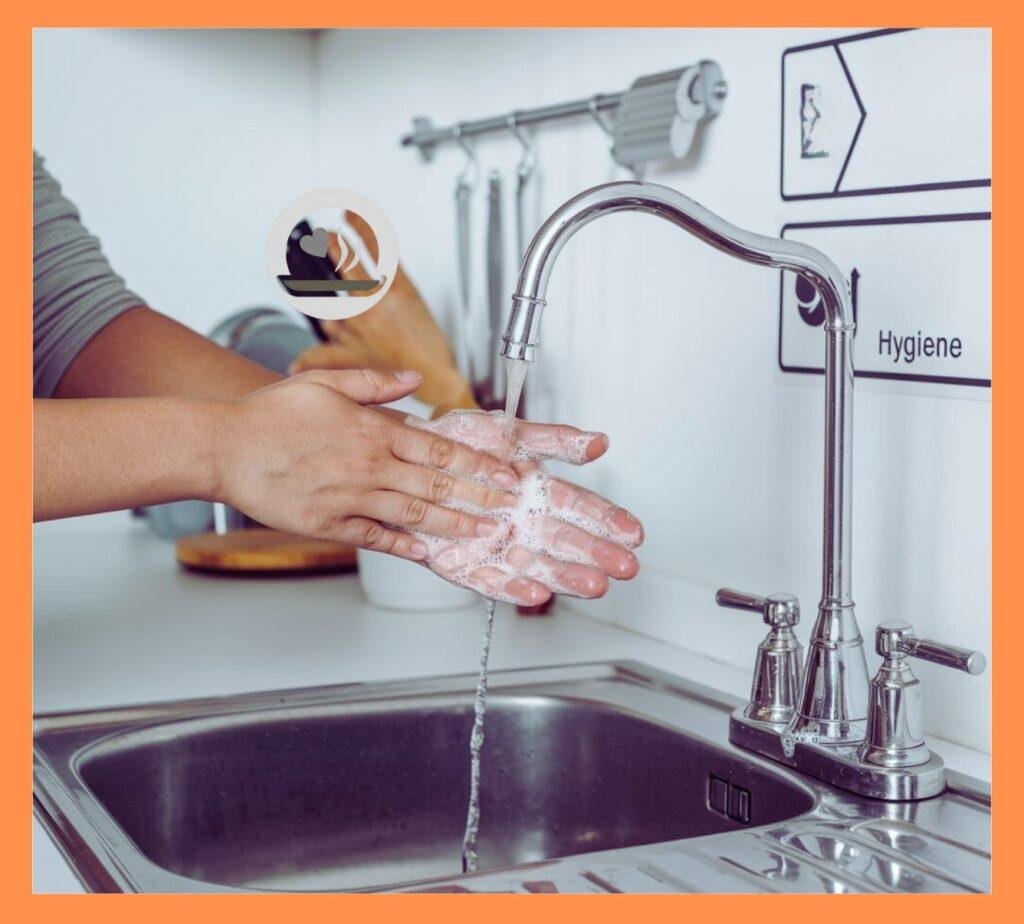 Person thoroughly washing hands with soap at a kitchen sink, scrubbing between fingers and under nails, clean white kitchen background, labeled steps for proper hygiene